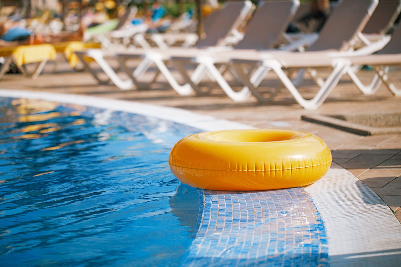 sparkling pool with yellow floatation device.