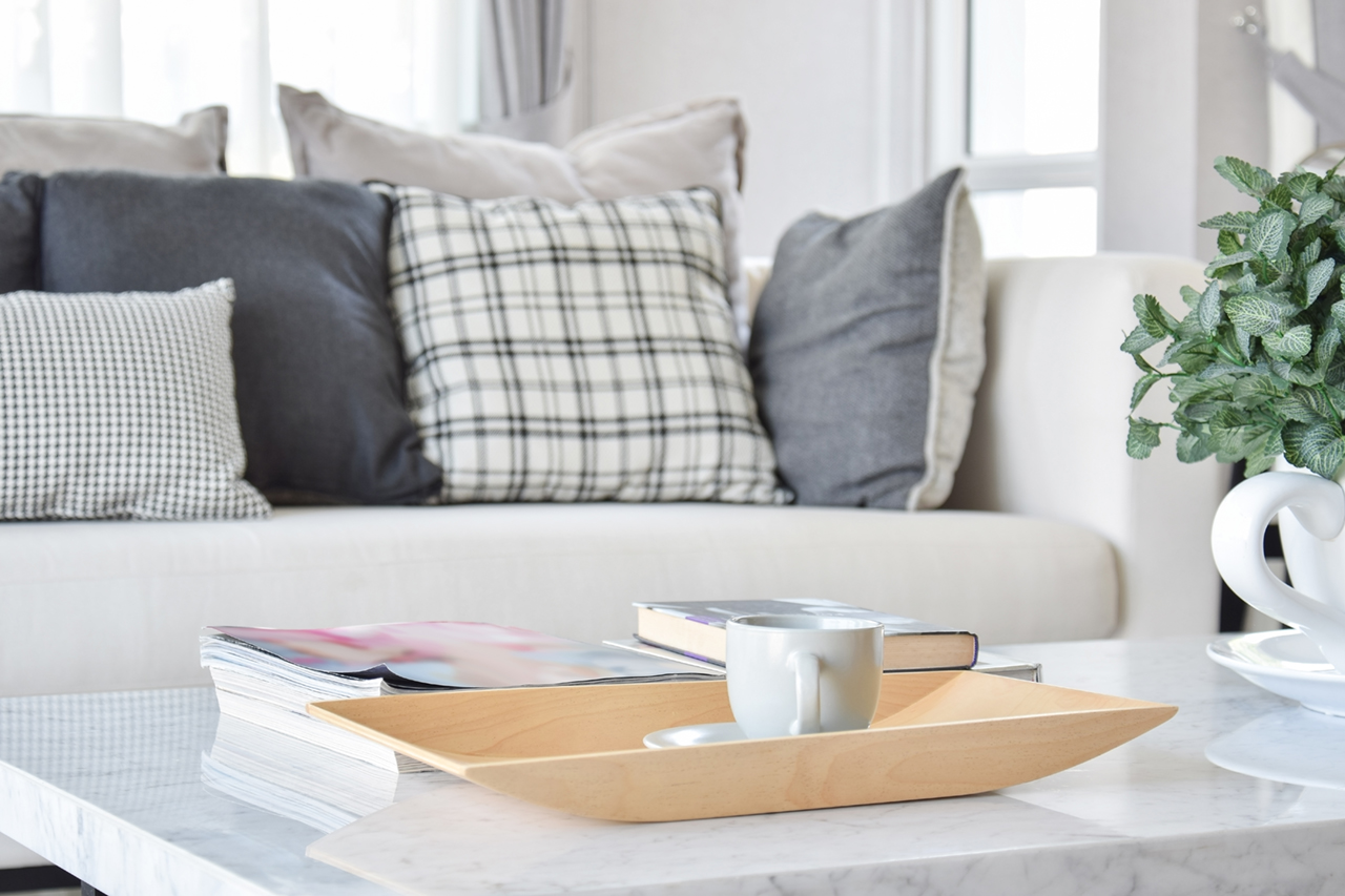 decorative-wooden-tray-with-tea-cup-and-books-in-modern-living-room-interior