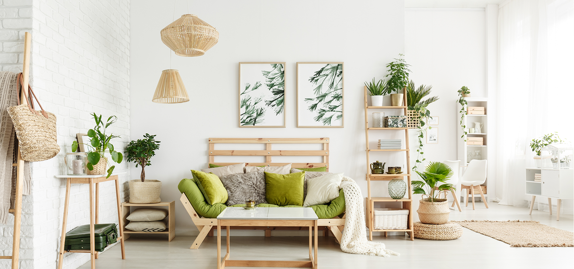 grey couches with green accent pillows