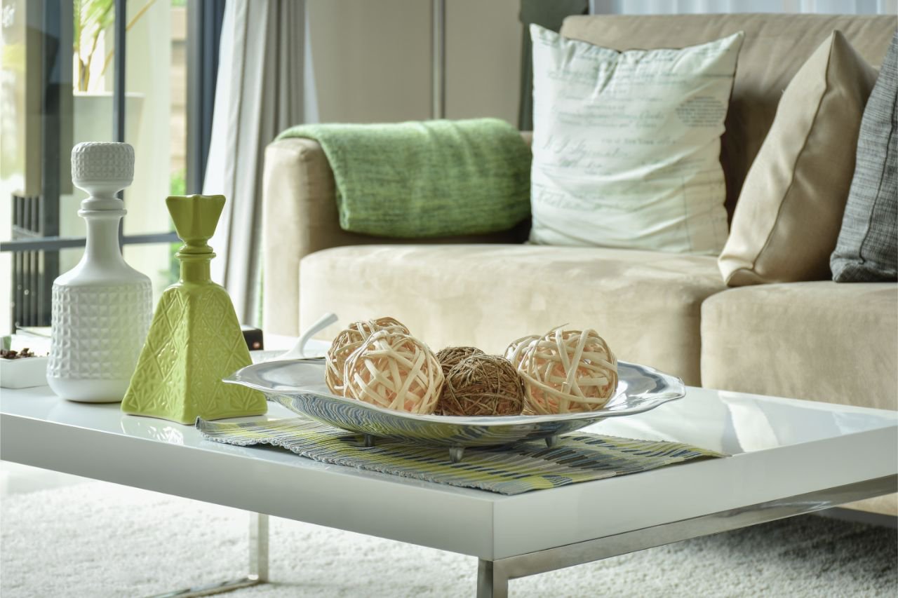 Tan suede counch with pillows in a decorathed livingroom